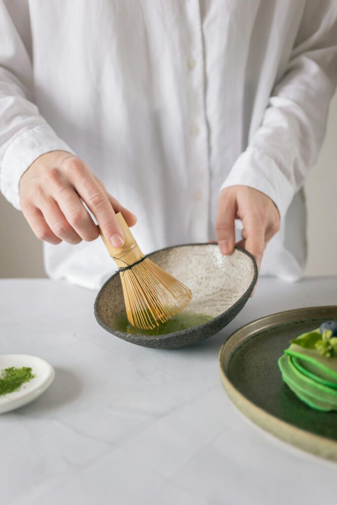 Crop person mixing ingredients in bowl